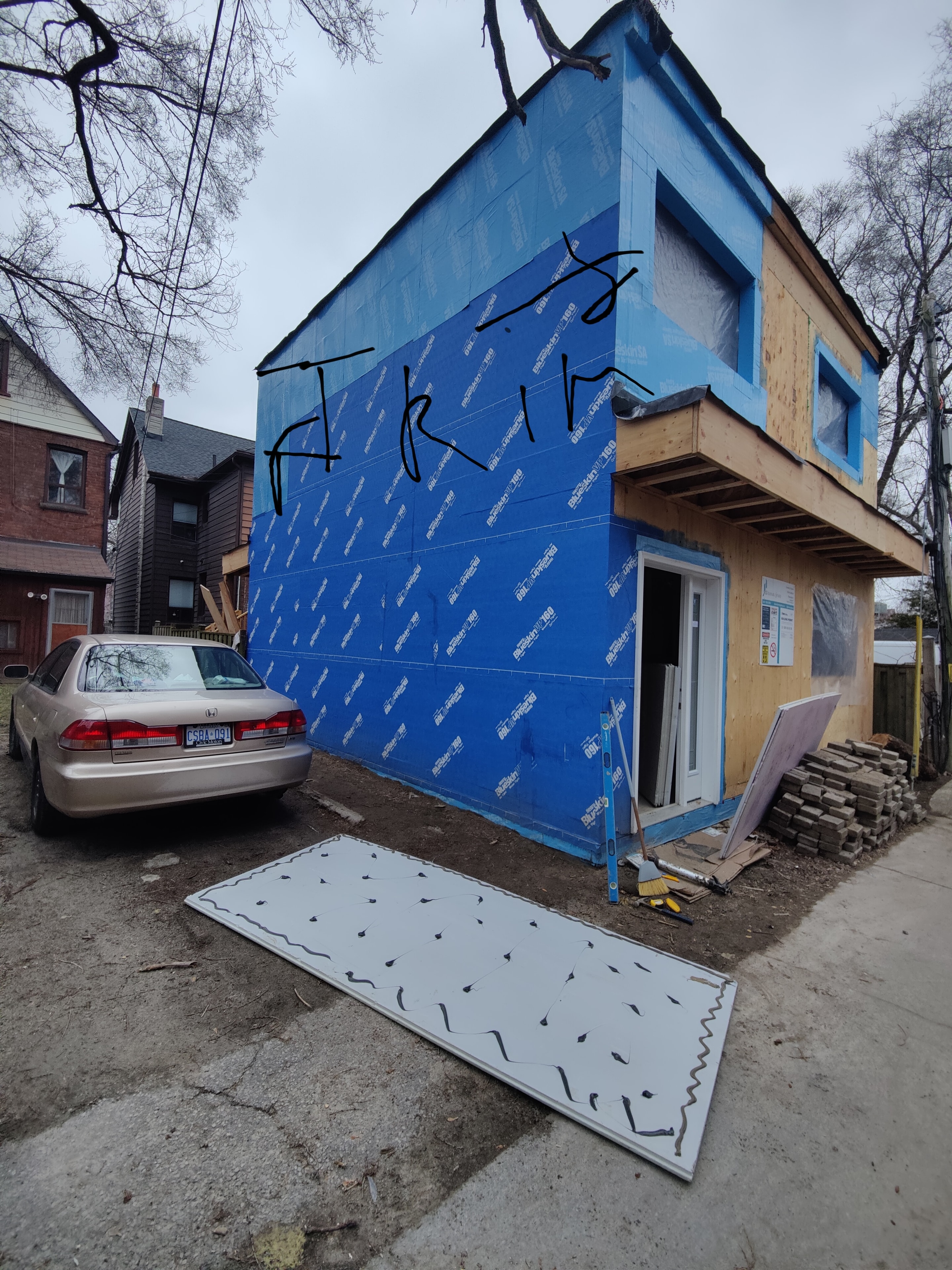 House with blue wrap siding preparation